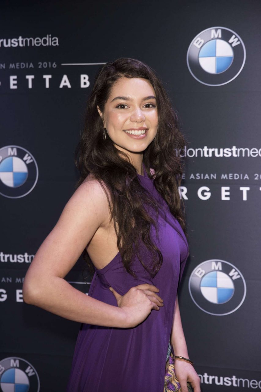 Sexy Side Pose Of Auli'i Cravalho In Purple Dress